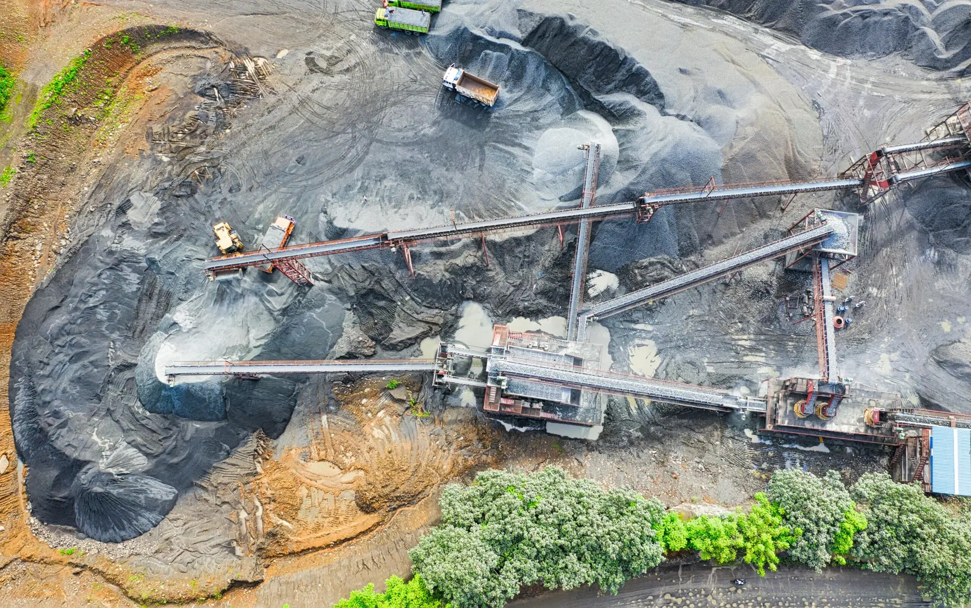 Drone capture of an industrial mining site with conveyor belts and machinery.